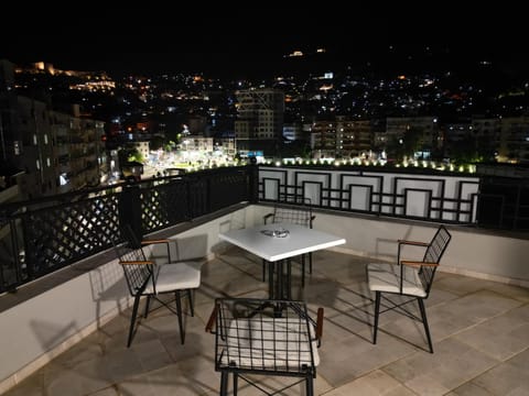 Property building, Patio, Night, View (from property/room), Balcony/Terrace, Seating area, Dining area, City view
