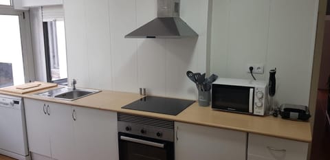 Kitchen or kitchenette, dishwasher, microwave, oven, stove