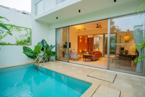 Property building, Patio, Day, Living room, Seating area, Pool view, Swimming pool, sunbed