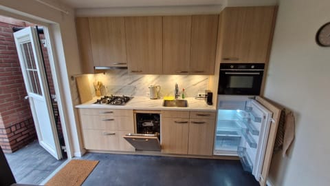 Kitchen or kitchenette, dishwasher, oven, stove