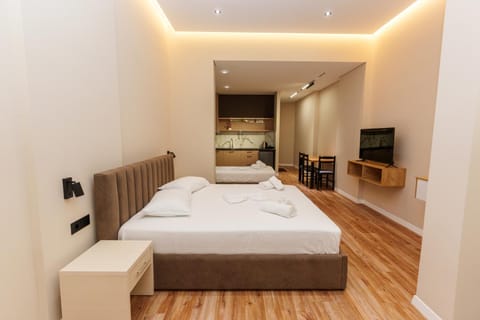 Bed, TV and multimedia, Living room, Seating area, Bedroom