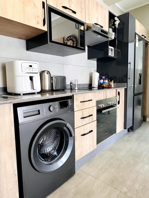 Kitchen or kitchenette, microwave, oven, stove, toaster, washing machine, dryer