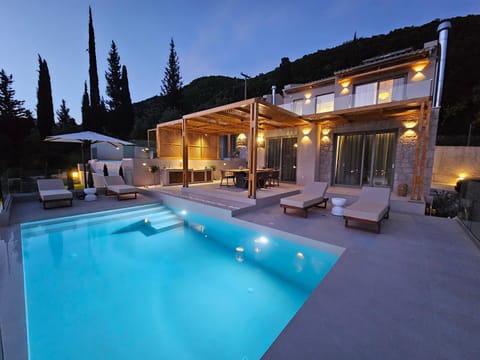 Property building, Patio, Night, Natural landscape, Mountain view, Pool view, Swimming pool, sunbed