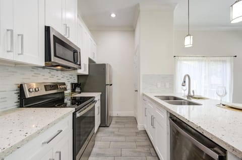 Kitchen or kitchenette, dishwasher, oven, stove