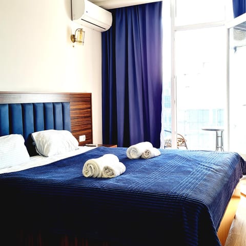Bed, Photo of the whole room, Bedroom, towels, air conditioner
