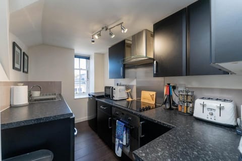 Kitchen or kitchenette, oven, stove, toaster, washing machine