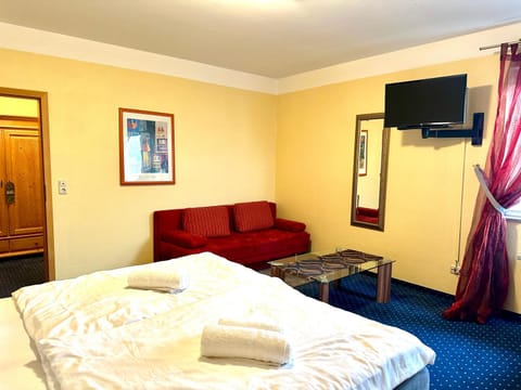 Bed, TV and multimedia, Seating area, towels, wardrobe