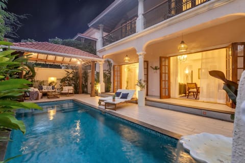 Property building, Patio, Night, Living room, Seating area, Pool view, Swimming pool, sunbed