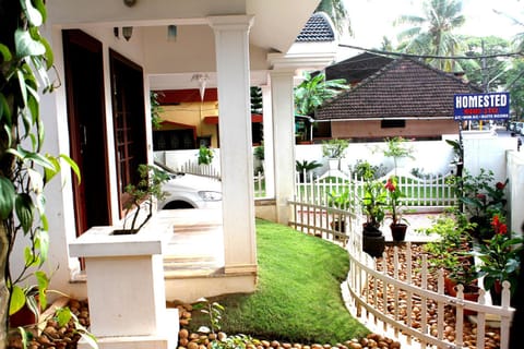 Property building, Patio, Facade/entrance, Property logo or sign, Garden, Lobby or reception, Garden view
