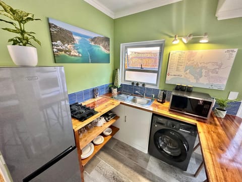 Kitchen or kitchenette, microwave, stove, washing machine