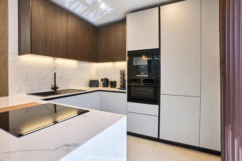 Kitchen or kitchenette, dishwasher, oven, stove