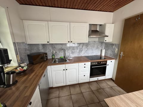 Kitchen or kitchenette, dishwasher, oven, stove