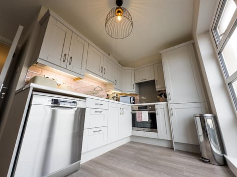 Kitchen or kitchenette, dishwasher, oven, stove, toaster