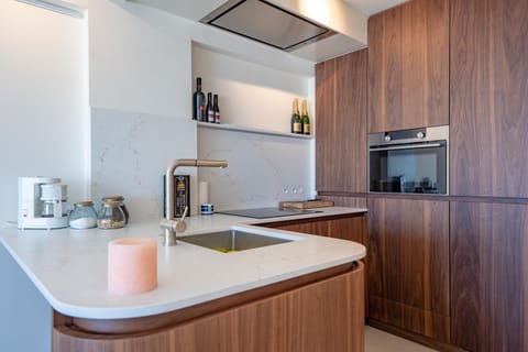 Kitchen or kitchenette, dishwasher, oven, stove