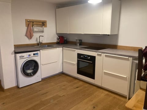 Kitchen or kitchenette, oven, stove, washing machine