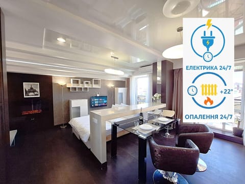 Bed, Property logo or sign, TV and multimedia, Kitchen or kitchenette, Photo of the whole room, Logo/Certificate/Sign, Bedroom, Text overlay, Certificate/Award, minibar, oven