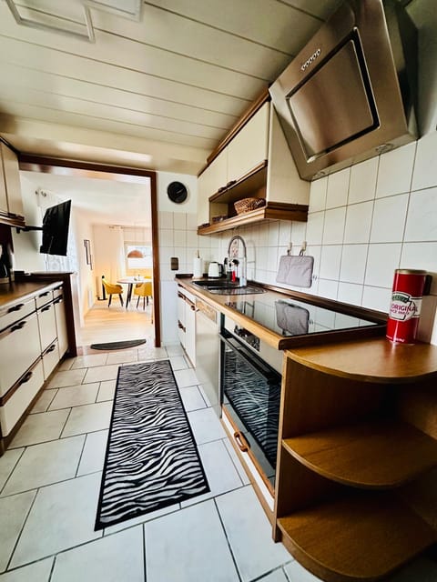 Kitchen or kitchenette, dishwasher, oven, stove