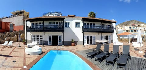 Property building, Patio, Day, Natural landscape, Pool view, Swimming pool, Swimming pool, sunbed
