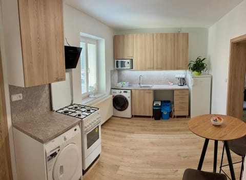 Kitchen or kitchenette, microwave, stove, washing machine, dryer