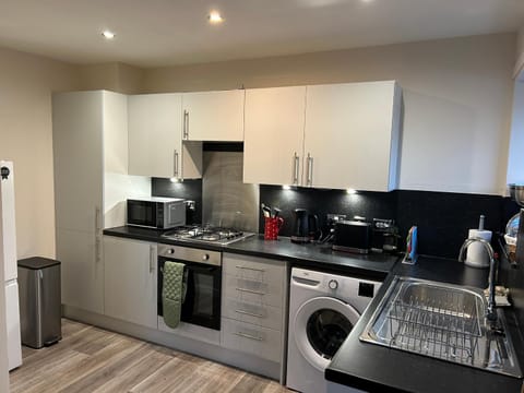 Kitchen or kitchenette, oven, stove, toaster, washing machine