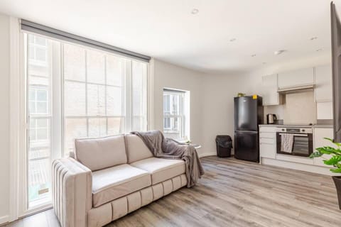 View (from property/room), Living room, Decorative detail, Seating area, City view, microwave, oven, stove, toaster, towels, washing machine, kitchen