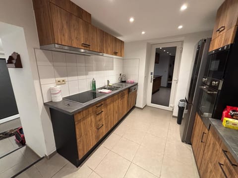 Kitchen or kitchenette, dishwasher, oven, stove