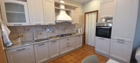 Kitchen or kitchenette, dishwasher, oven, stove