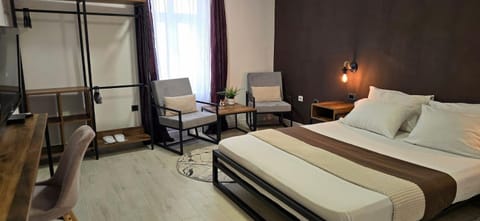 Bed, TV and multimedia, Living room, Seating area, Bedroom