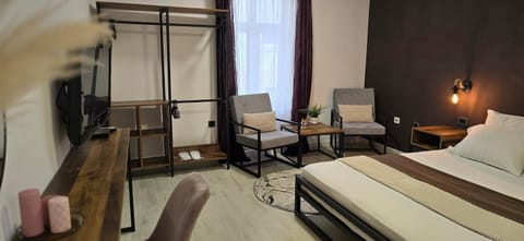 Bed, TV and multimedia, Living room, Seating area, Bedroom