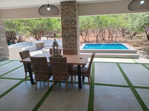 Property building, Patio, Seating area, Swimming pool
