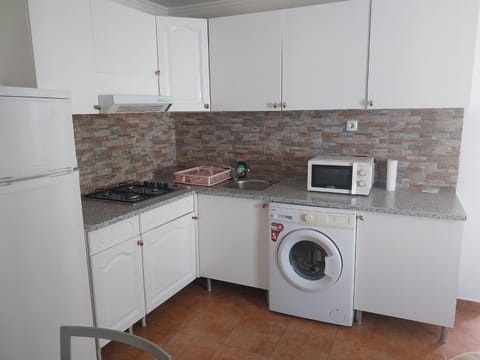 Kitchen or kitchenette, stove, washing machine