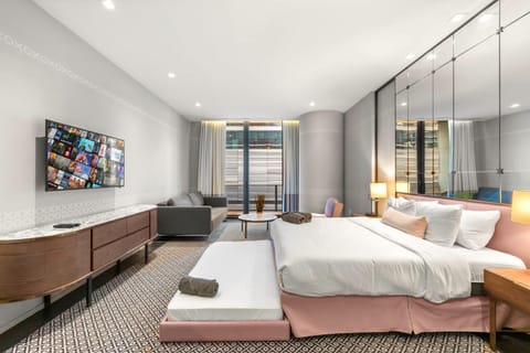 Bed, TV and multimedia, Living room, Seating area, Bedroom, air conditioner
