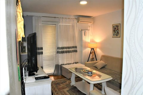 Bed, TV and multimedia, Living room, Seating area, air conditioner