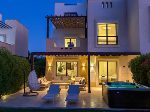 Property building, Patio, Night, Living room, Seating area, Evening entertainment, Pool view, sunbed