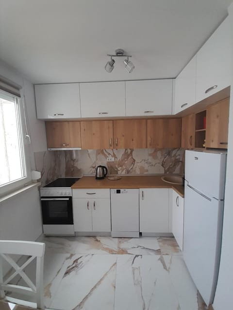 Kitchen or kitchenette, dishwasher, oven, stove