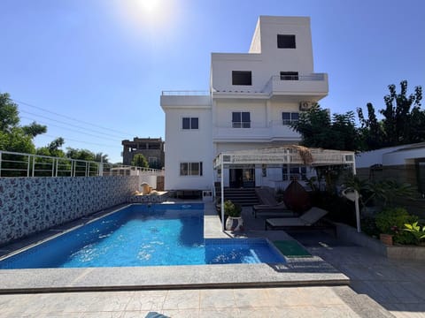 Property building, Patio, Pool view, Swimming pool, sunbed