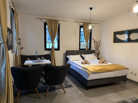 Bed, TV and multimedia, Living room, Seating area, Bedroom