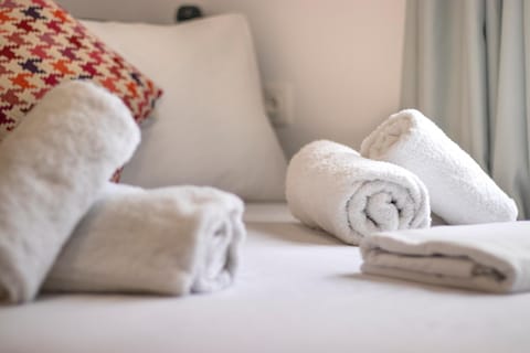 Bed, Photo of the whole room, Bedroom, hair dryier, towels, air conditioner