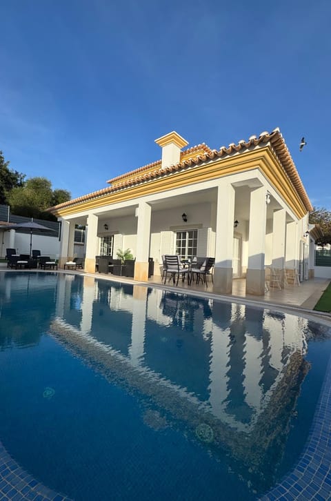 Property building, Patio, Pool view, Swimming pool, sunbed