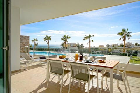 Patio, Natural landscape, View (from property/room), Balcony/Terrace, Seating area, Dining area, Pool view, Sea view, Swimming pool