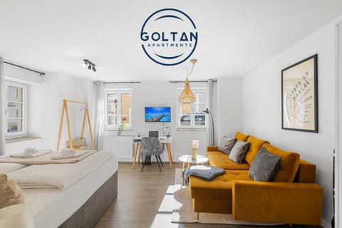 Bed, Property logo or sign, TV and multimedia, Living room, Photo of the whole room, Seating area, Logo/Certificate/Sign, Bedroom