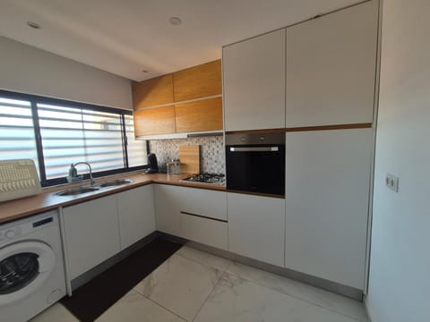 Kitchen or kitchenette, oven, stove, washing machine