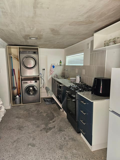 Kitchen or kitchenette, dishwasher, oven, stove, toaster, washing machine, dryer