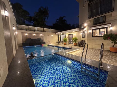 Property building, Patio, Night, Pool view, Swimming pool