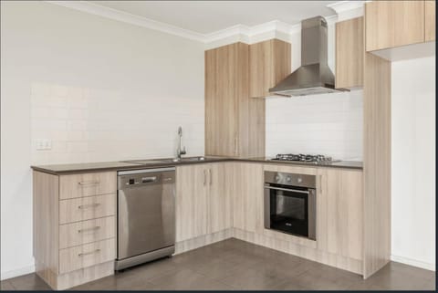 Kitchen or kitchenette, dishwasher, oven, stove