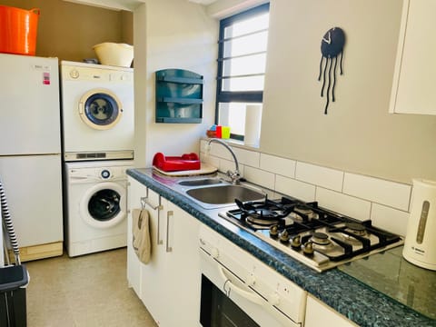 Kitchen or kitchenette, oven, stove, washing machine