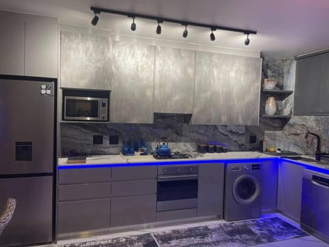 Kitchen or kitchenette, dishwasher, oven, stove, washing machine
