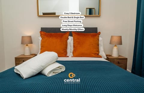 Bed, Property logo or sign, Photo of the whole room, Logo/Certificate/Sign, Bedroom, Text overlay, Certificate/Award, towels