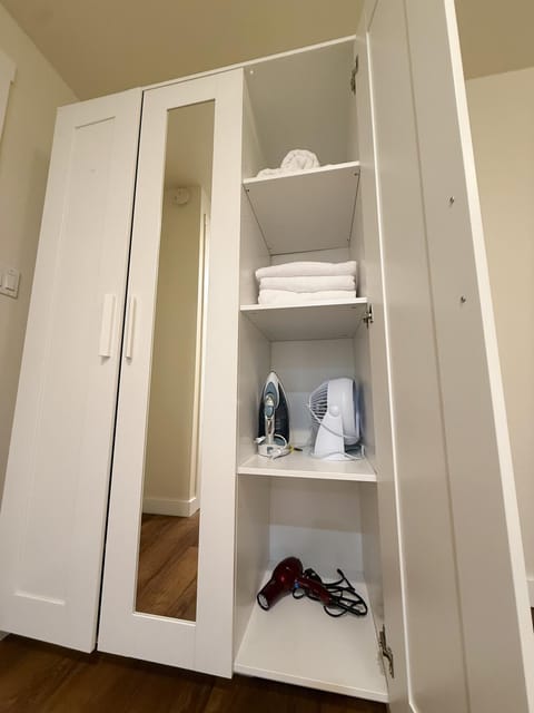 Bedroom, flat iron, hair dryier, towels