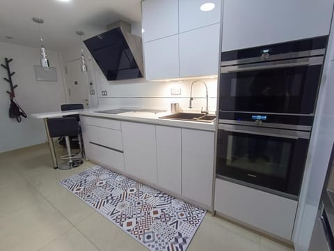 Kitchen or kitchenette, microwave, oven, stove